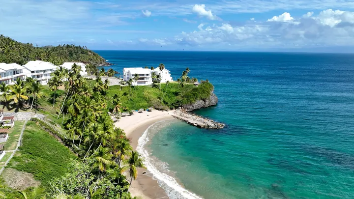 Aerial view of the private beach and turquoise water below Vista Mare